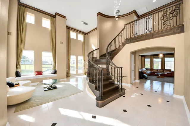a living room with fireplace furniture and a large window