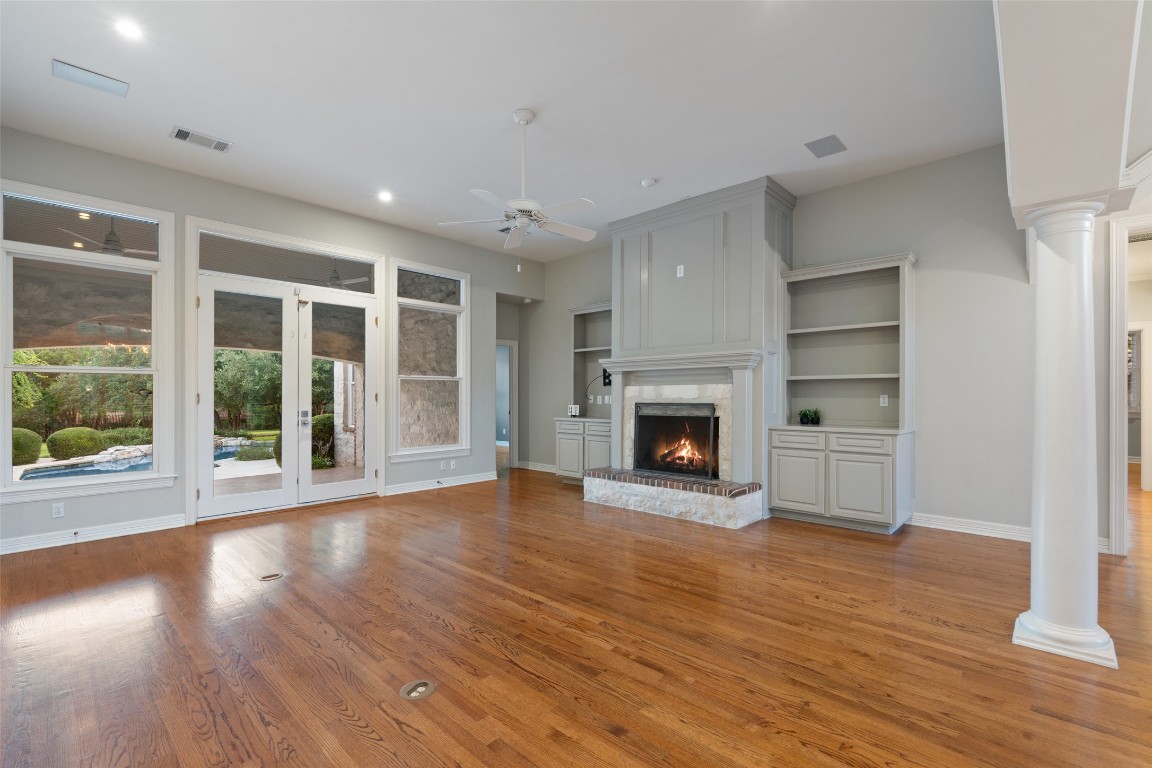 127 Roberts Circle Georgetown, TX 78633 - Photo 11 of 35 a view of an empty room with wooden floor fireplace and a window