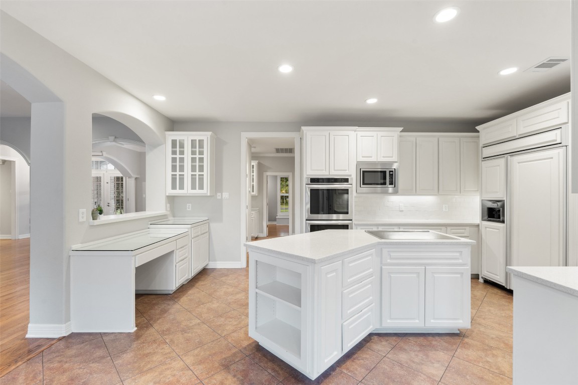 127 Roberts Circle Georgetown, TX 78633 - Photo 16 of 35 a kitchen with white cabinets and white appliances