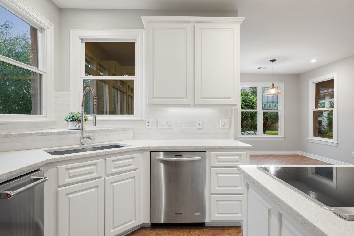 127 Roberts Circle Georgetown, TX 78633 - Photo 18 of 35 a kitchen with white cabinets and a sink