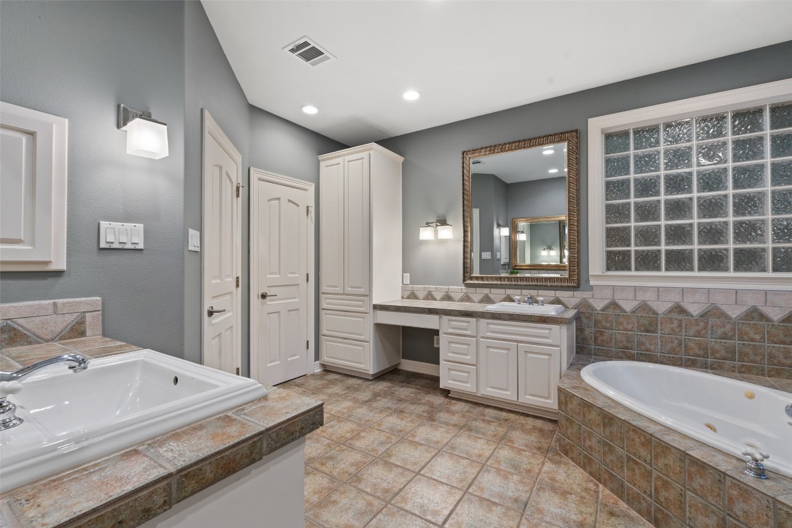 127 Roberts Circle Georgetown, TX 78633 - Photo 24 of 35 a spacious bathroom with a granite countertop tub sink and mirror