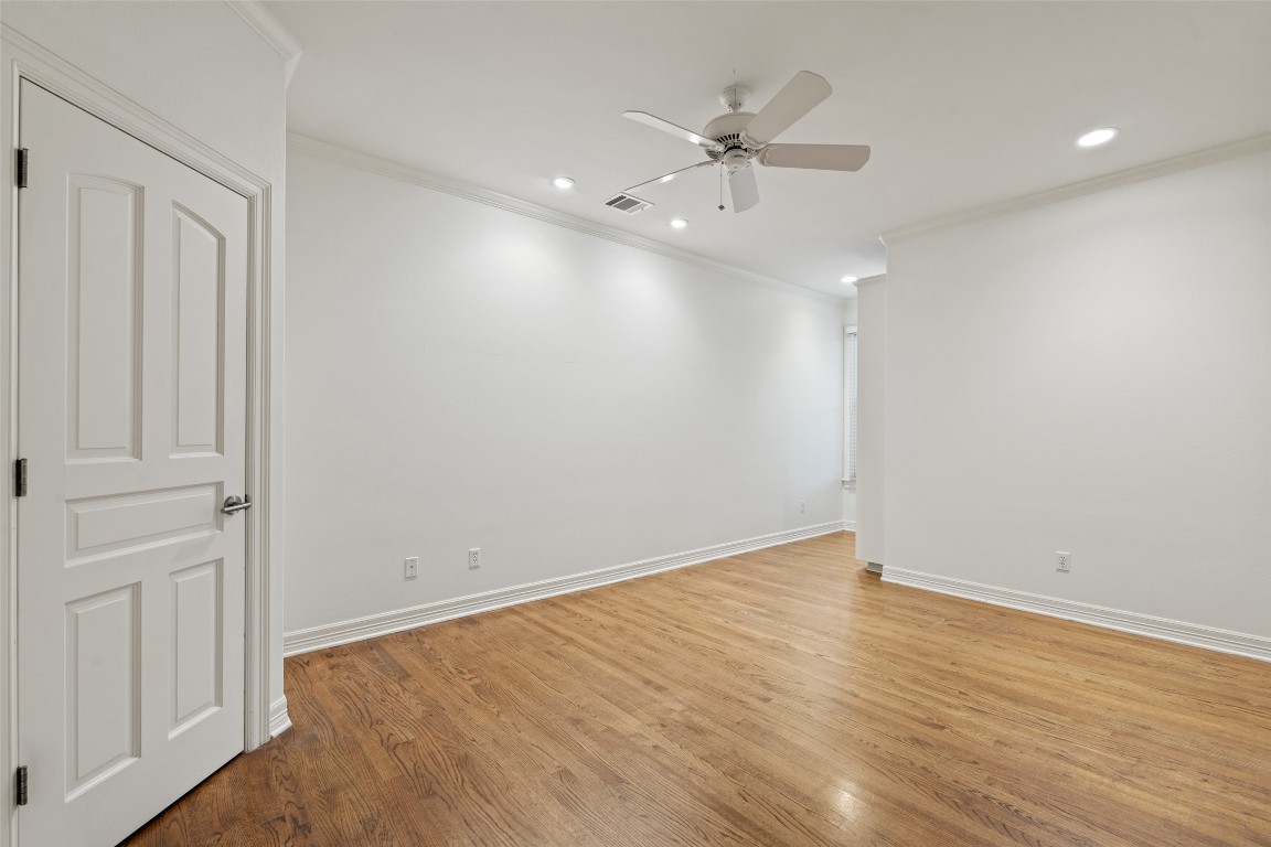 127 Roberts Circle Georgetown, TX 78633 - Photo 3 of 35 an empty room with wooden floor and fan