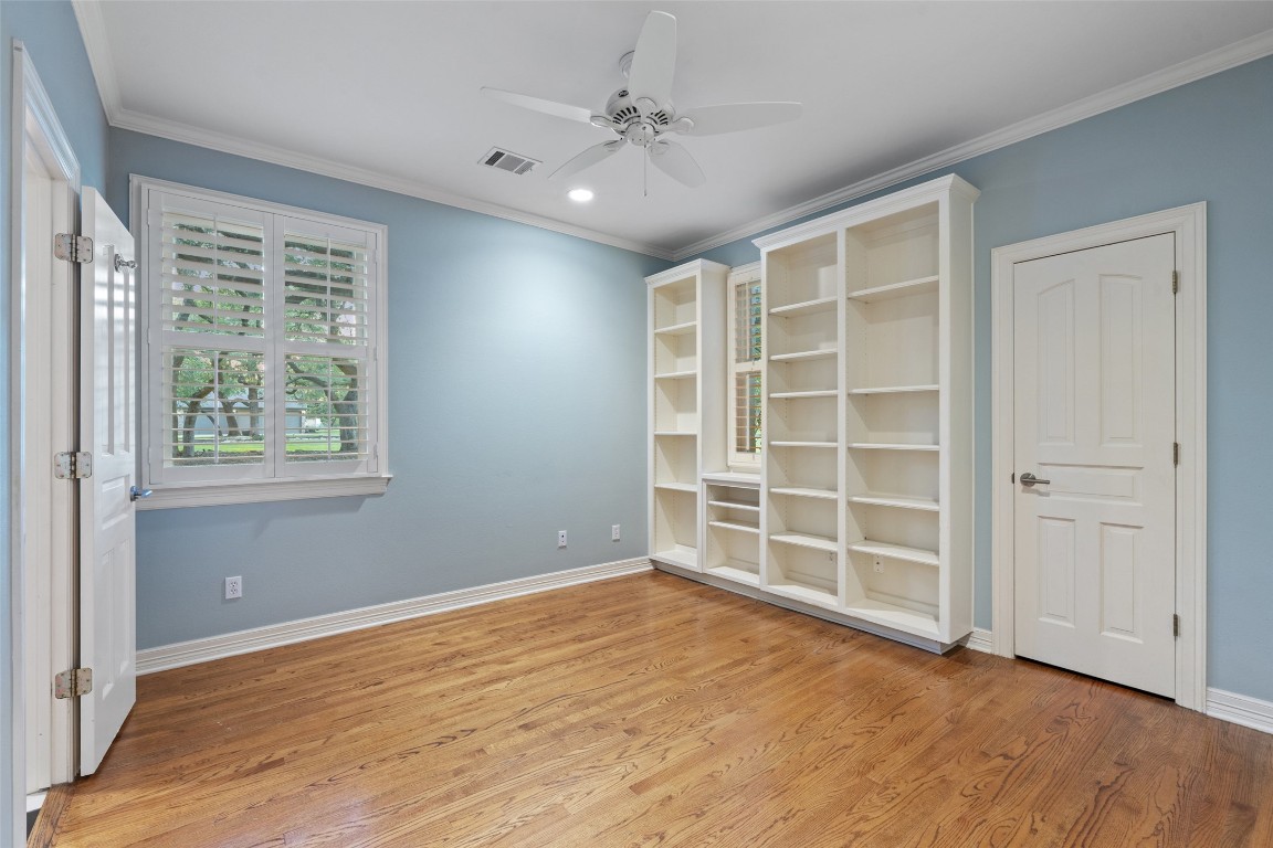 127 Roberts Circle Georgetown, TX 78633 - Photo 6 of 35 an empty room with cabinet and windows