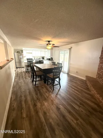 a view of a dining room with furniture and window