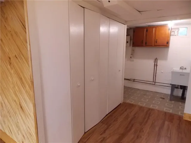 a view of a livingroom with wooden floor and a sink