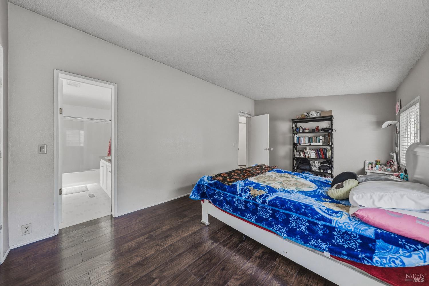 436 McCoy Avenue Santa Rosa, CA 95407 - Photo 15 of 27 a bedroom with a bed and wooden floor