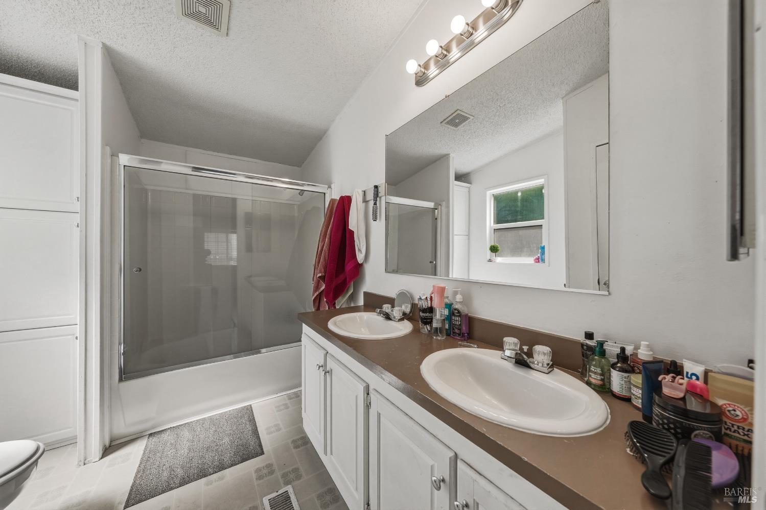 436 McCoy Avenue Santa Rosa, CA 95407 - Photo 16 of 27 a bathroom with a double vanity sink mirror and shower