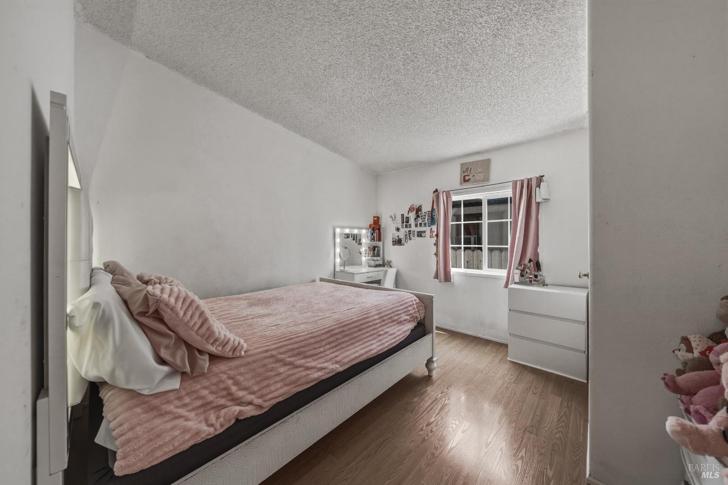 436 McCoy Avenue Santa Rosa, CA 95407 - Photo 17 of 27 a bedroom with a bed and wooden floor