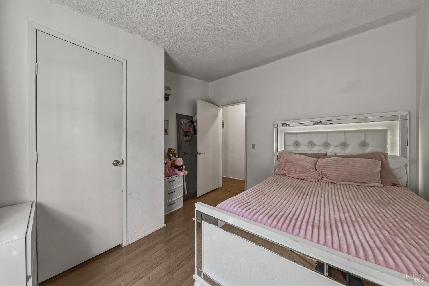 436 McCoy Avenue Santa Rosa, CA 95407 - Photo 18 of 27 a bedroom with a large bed and wooden floor