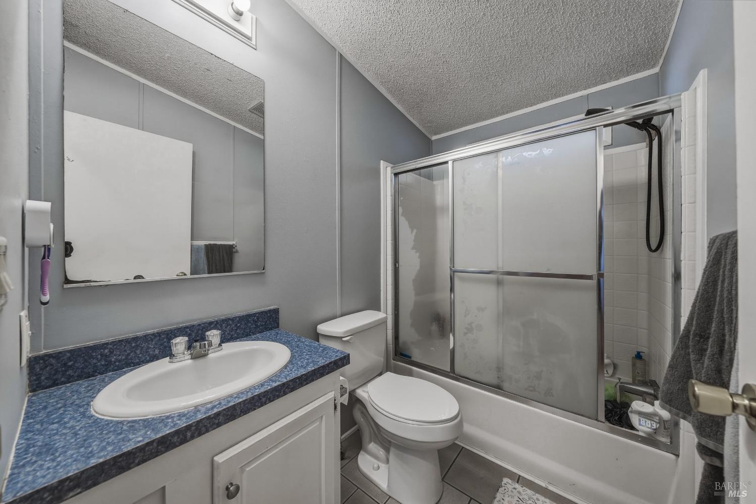 436 McCoy Avenue Santa Rosa, CA 95407 - Photo 19 of 27 a bathroom with a granite countertop sink toilet and shower