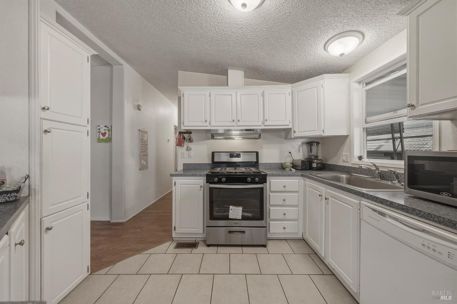 436 McCoy Avenue Santa Rosa, CA 95407 - Photo 9 of 27 a kitchen with stainless steel appliances granite countertop a stove and a refrigerator