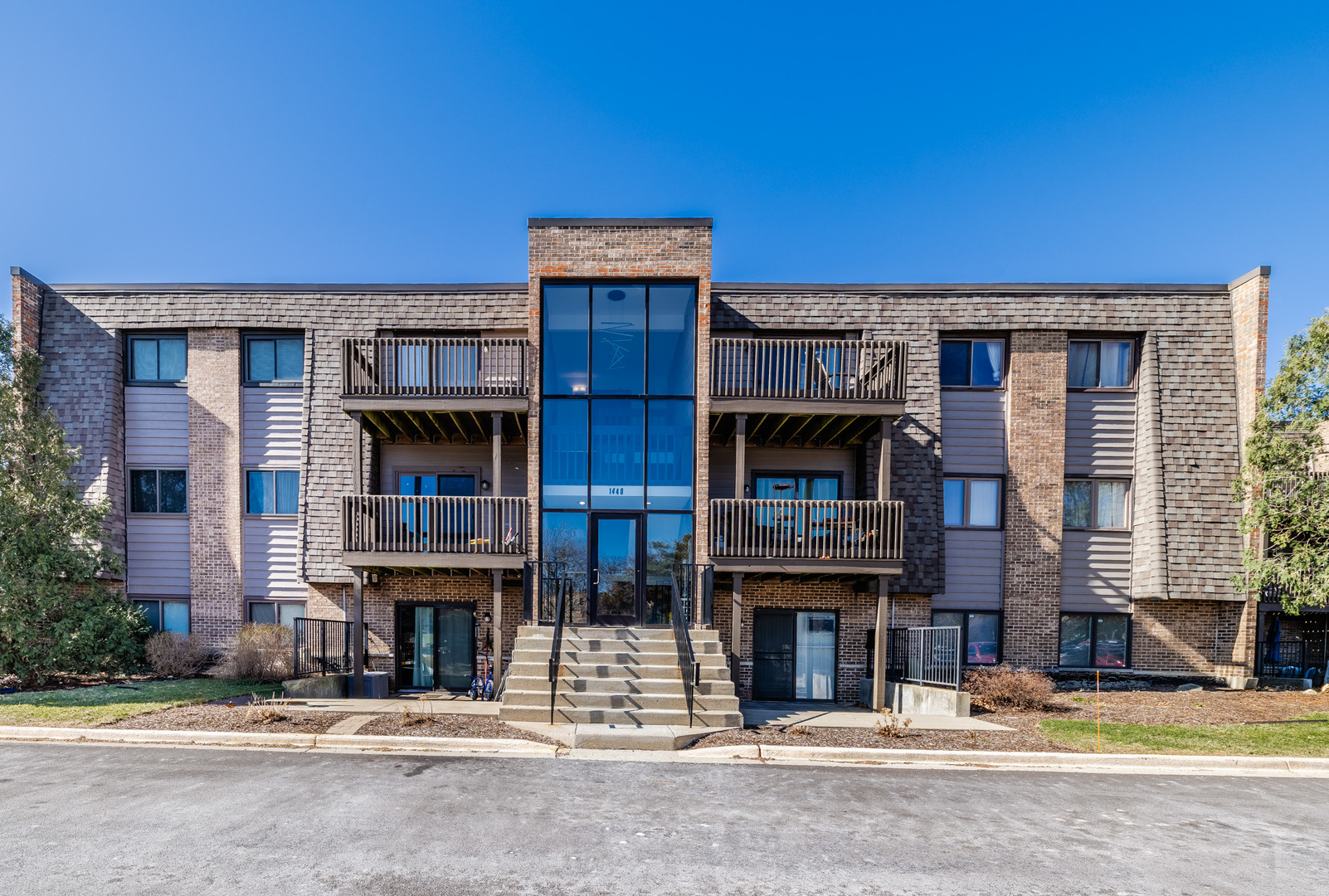 1440 Stonebridge Circle, Unit J7 Wheaton, IL 60189 - Photo 1 of 28 a front view of a building with street