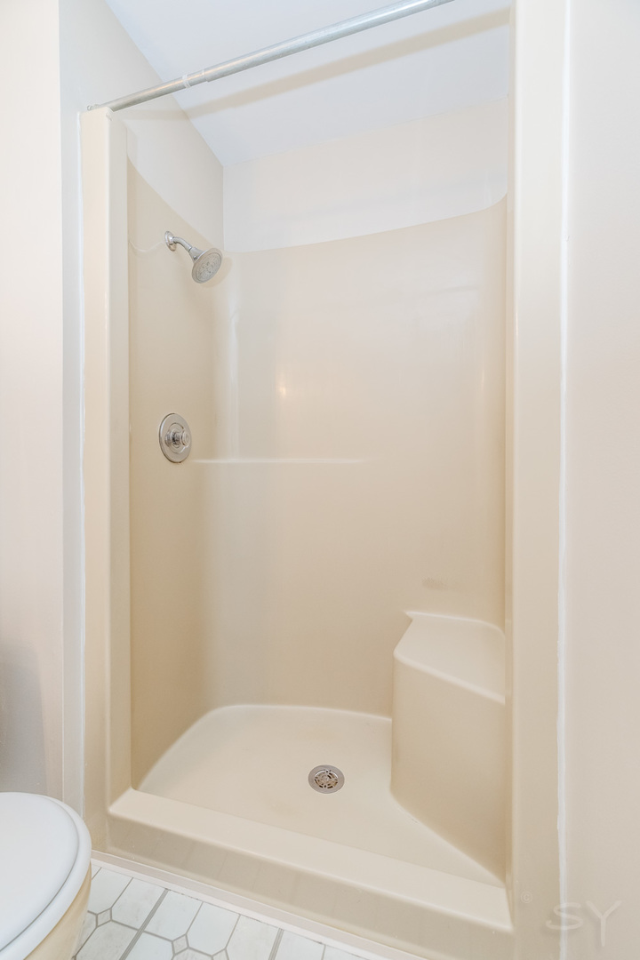 1440 Stonebridge Circle, Unit J7 Wheaton, IL 60189 - Photo 16 of 28 a bathroom with a shower and a toilet