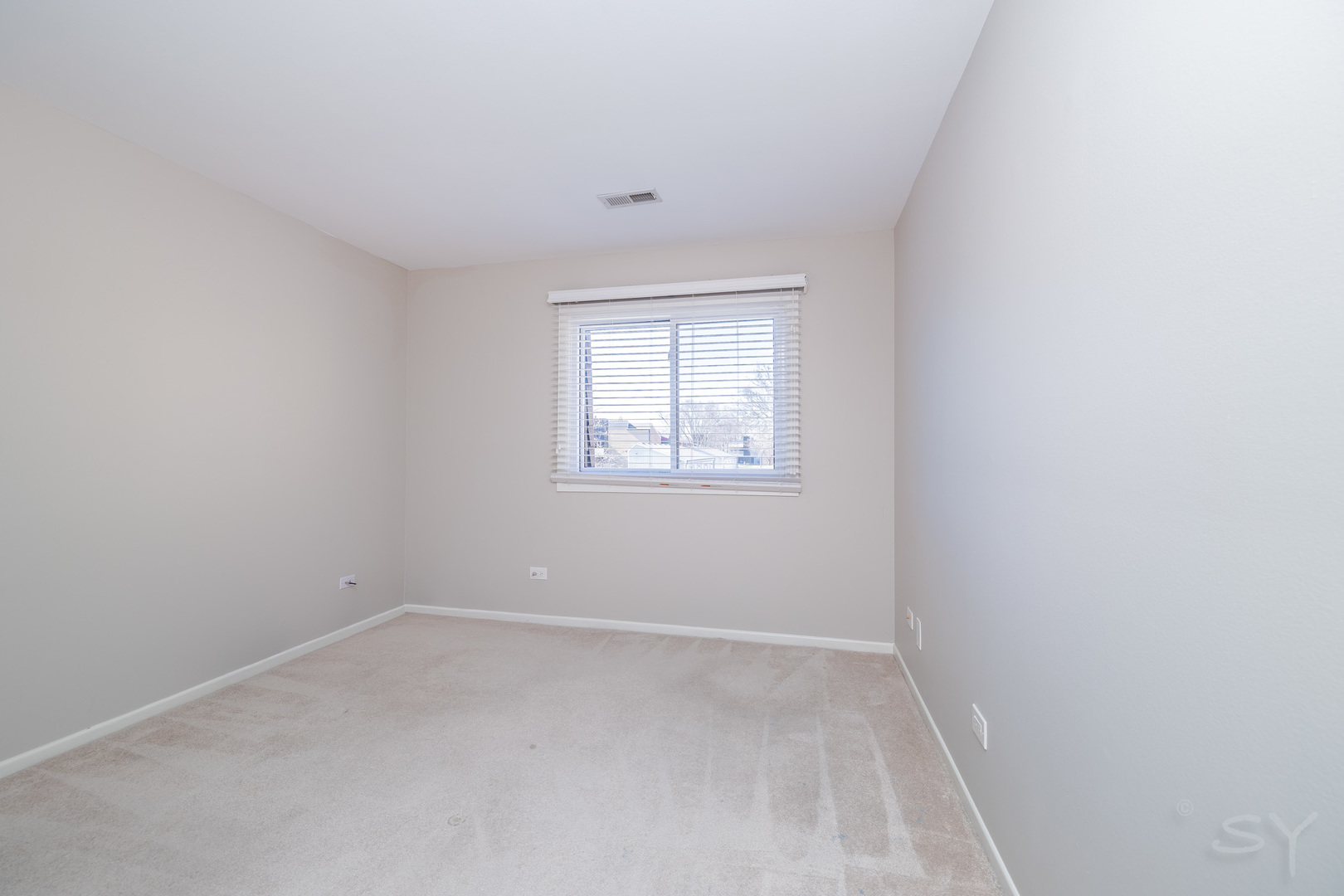 1440 Stonebridge Circle, Unit J7 Wheaton, IL 60189 - Photo 17 of 28 an empty room with a window