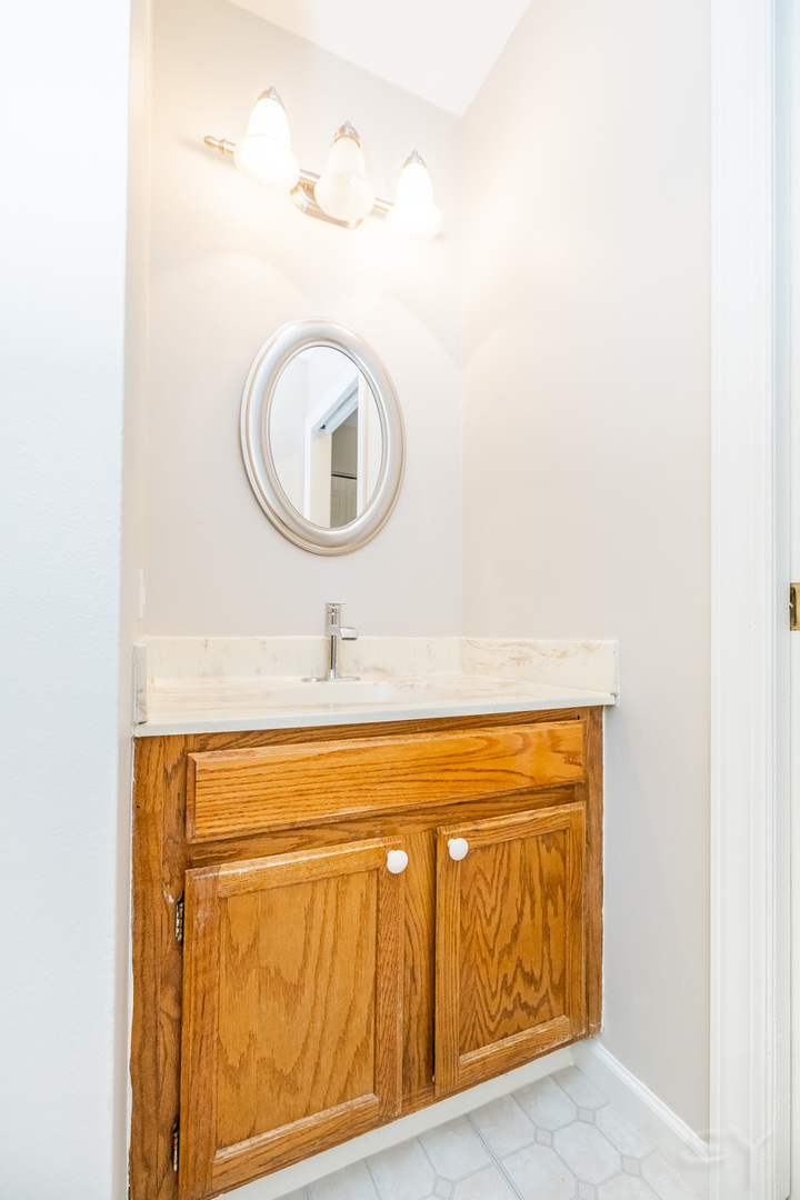 1440 Stonebridge Circle, Unit J7 Wheaton, IL 60189 - Photo 19 of 28 a bathroom with a sink and a mirror