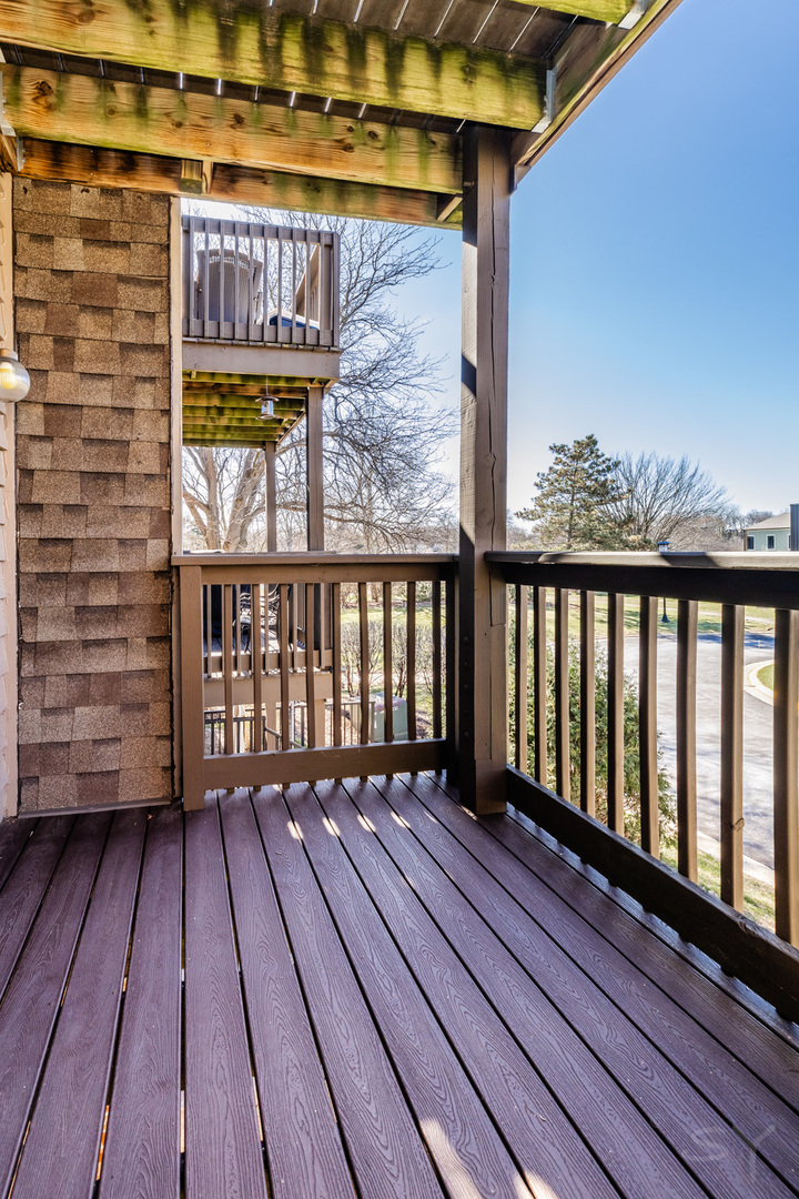 1440 Stonebridge Circle, Unit J7 Wheaton, IL 60189 - Photo 21 of 28 a view of a balcony with wooden floor