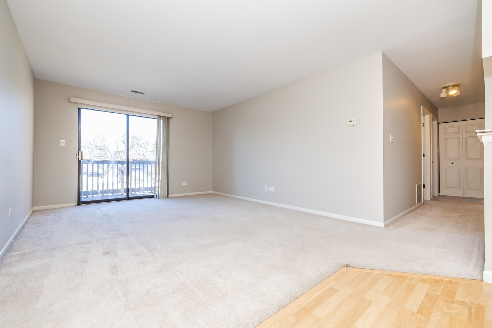 1440 Stonebridge Circle, Unit J7 Wheaton, IL 60189 - Photo 3 of 28 an empty room with windows