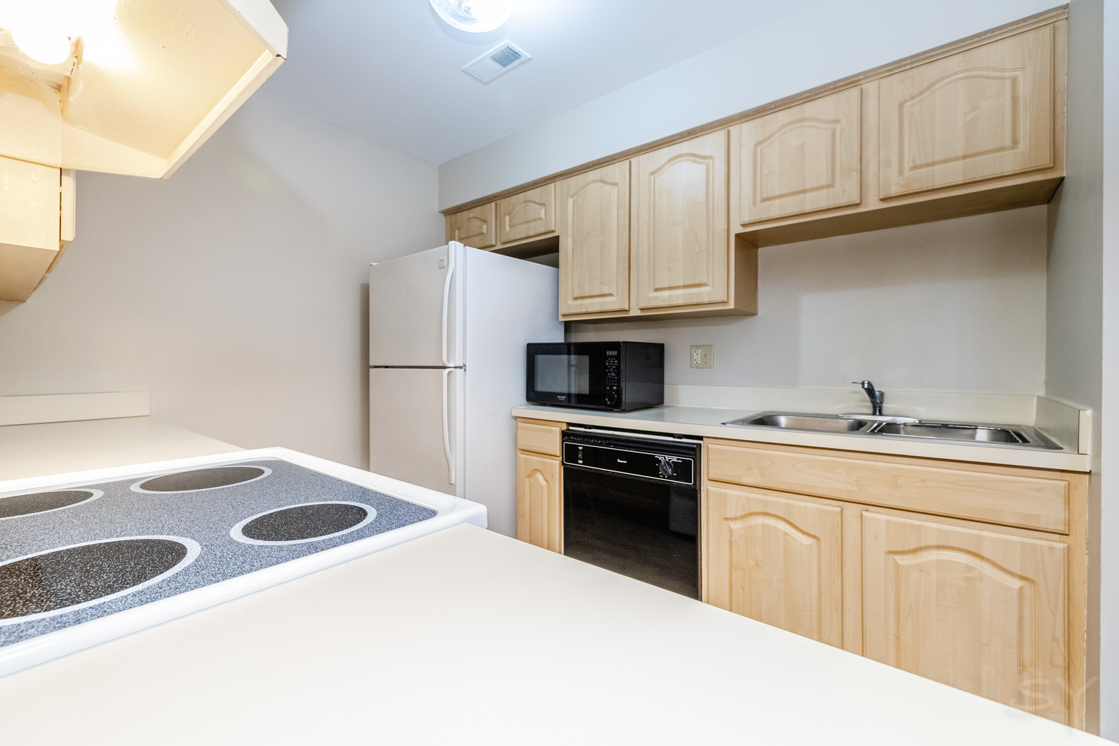 1440 Stonebridge Circle, Unit J7 Wheaton, IL 60189 - Photo 8 of 28 a kitchen with granite countertop a sink stove and refrigerator