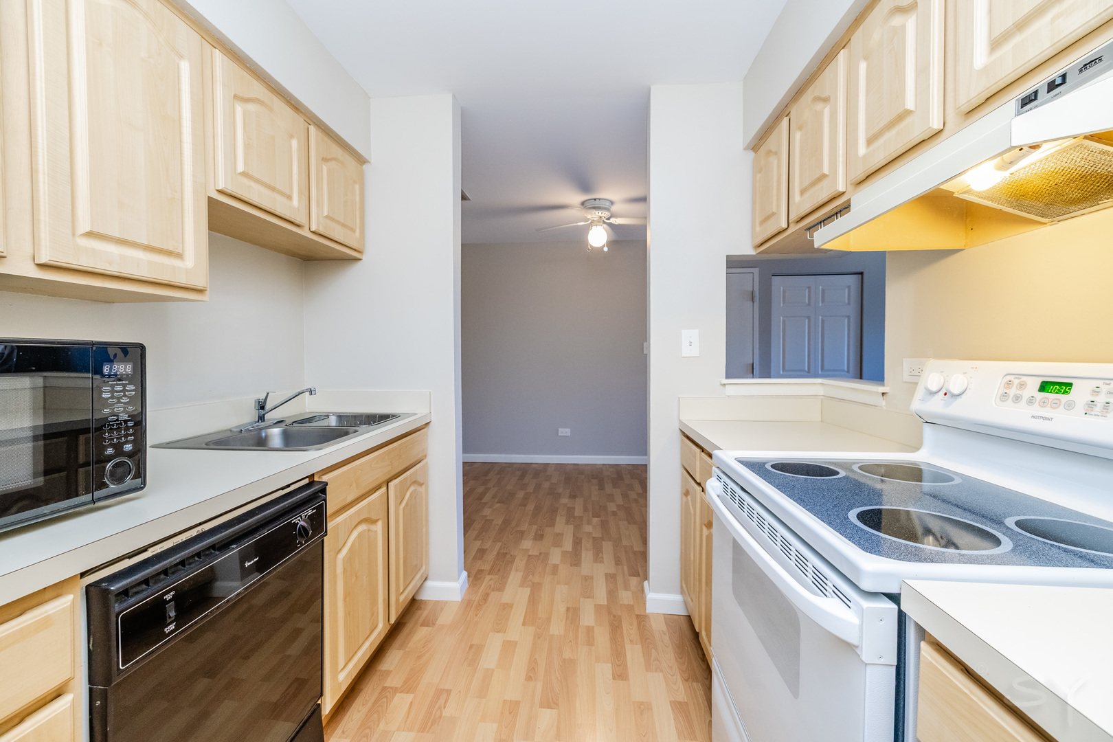 1440 Stonebridge Circle, Unit J7 Wheaton, IL 60189 - Photo 9 of 28 a kitchen with a sink a stove and cabinets