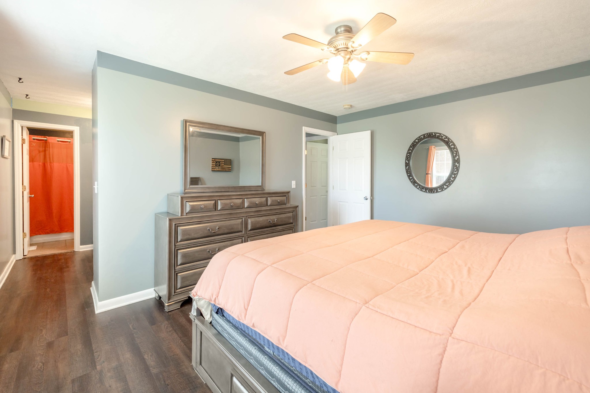135 Corinth Road Portland, TN 37148 - Photo 28 of 44 a bedroom with a bed and a chandelier