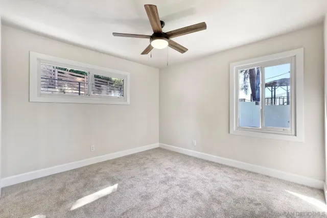 an aerial view of residential house with parking and trees