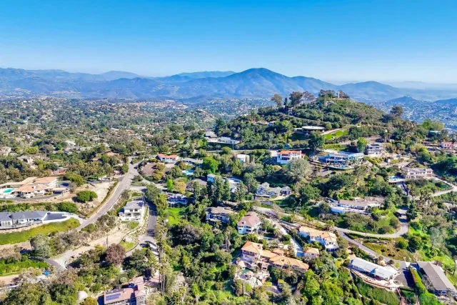 an aerial view of a house with swimming pool and porch