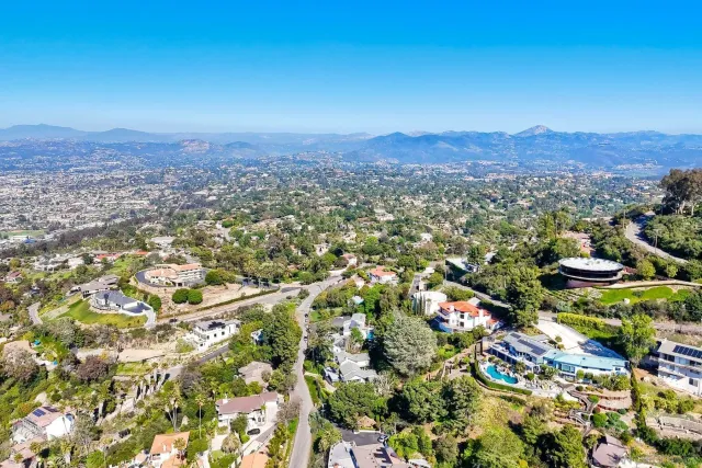 an aerial view of a house with a garden and trees