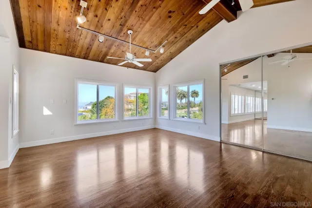 a view of a livingroom with wooden floor and a flat screen tv
