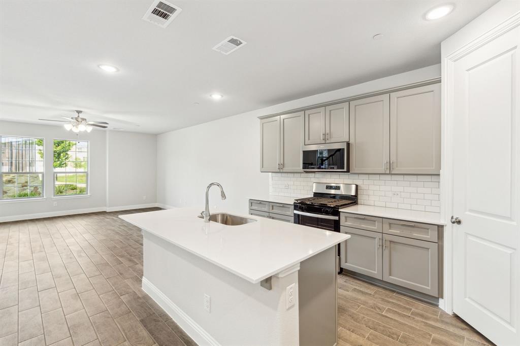 a kitchen with a sink stove and microwave