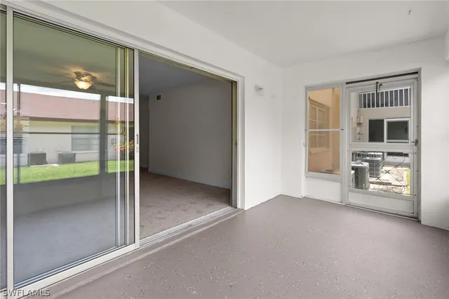 a view of an empty room with window and fire place