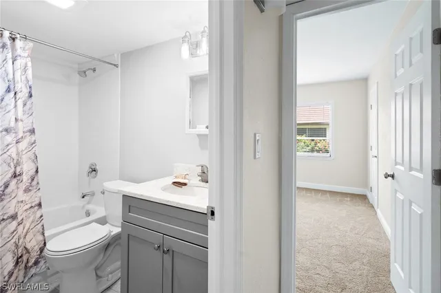 a bathroom with a sink toilet vanity and shower