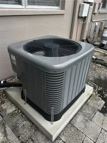 a view of a white house in a big yard with plants