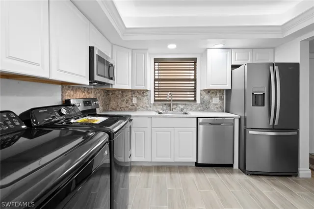 a kitchen with a stove a sink and a refrigerator