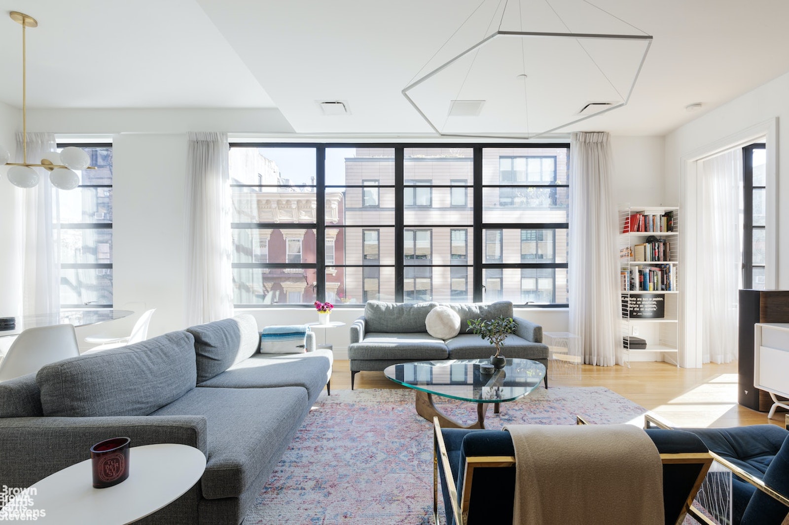 10 Sullivan Street, Unit 4C Manhattan, NY 10012 - Photo 1 of 1 a living room with furniture and a window
