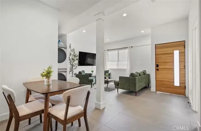 a view of a livingroom with furniture and a flat screen tv