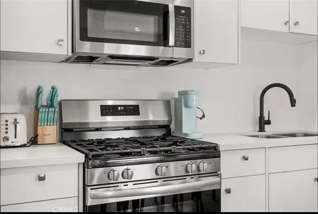 a stove top oven sitting inside of a kitchen