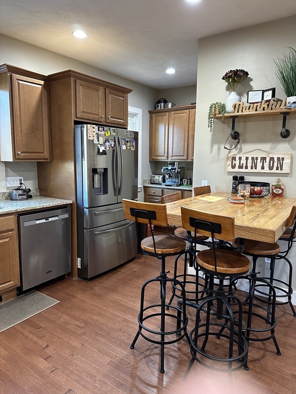 369 Chestnut Street Clinton, MA 01510 - Photo 2 of 21 a kitchen with stainless steel appliances a table chairs and a refrigerator