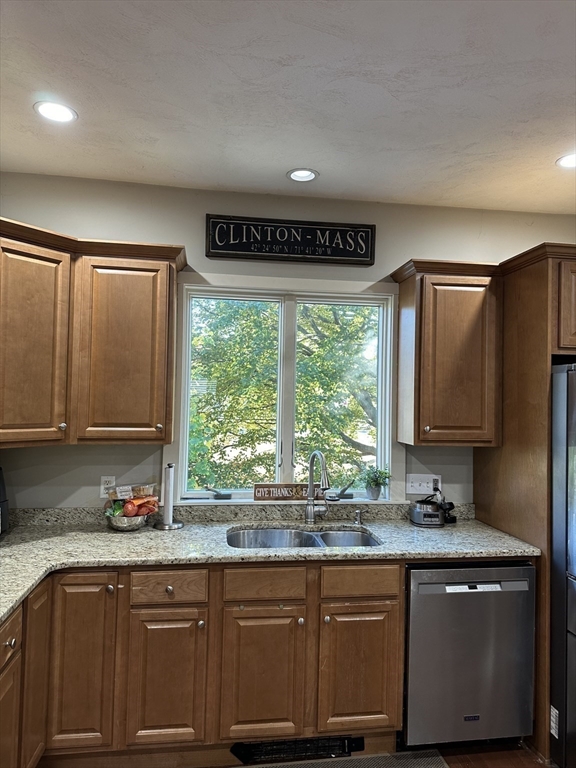 369 Chestnut Street Clinton, MA 01510 - Photo 3 of 21 a kitchen with granite countertop a stove a sink a window and cabinets