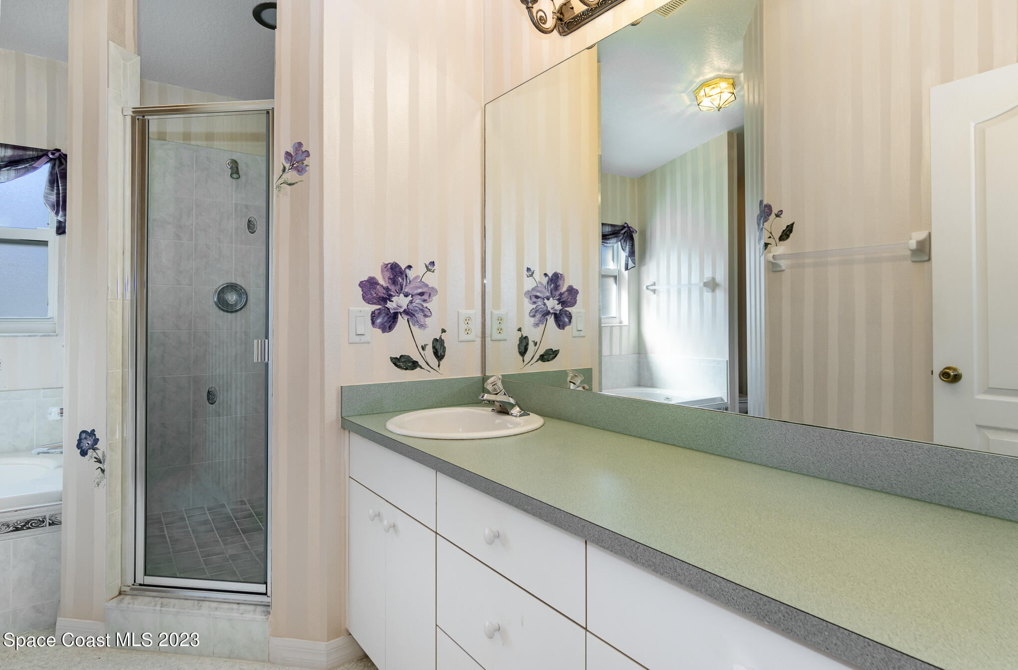 2140 Spring Creek Circle Palm Bay, FL 32905 - Photo 14 of 22 a bathroom with a granite countertop sink and a mirror