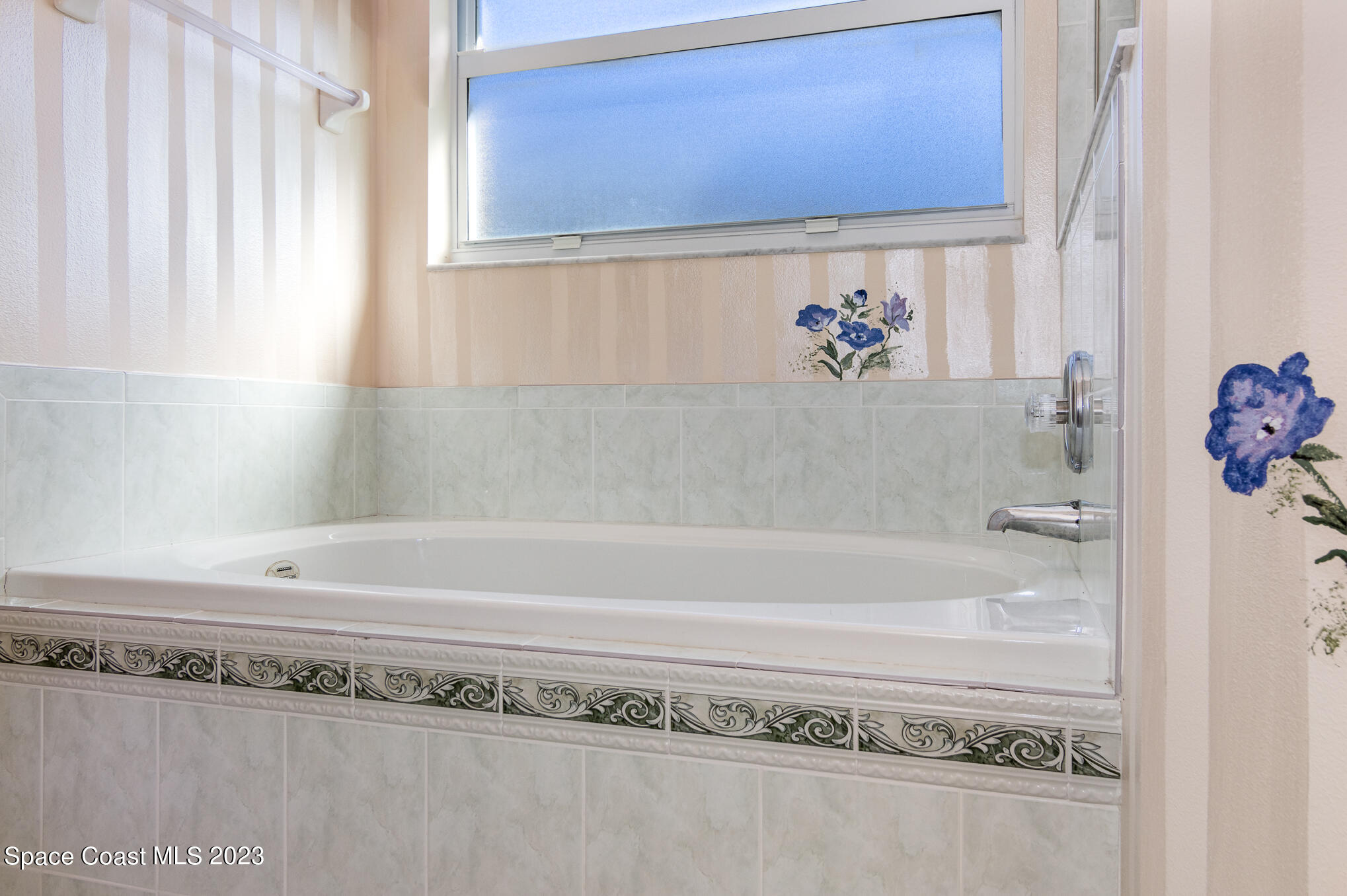 2140 Spring Creek Circle Palm Bay, FL 32905 - Photo 15 of 22 a bathroom with a bathtub and a shower