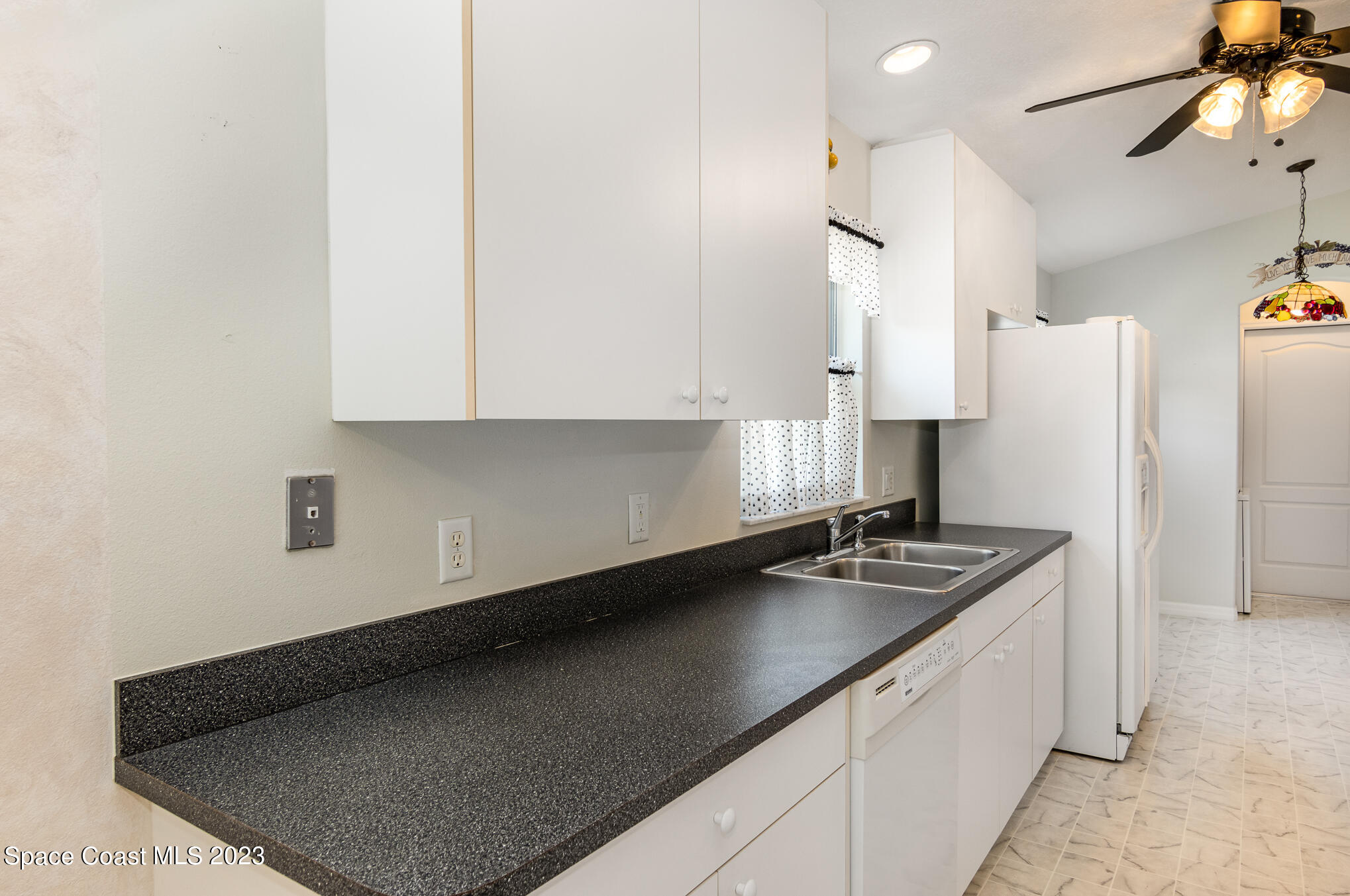 2140 Spring Creek Circle Palm Bay, FL 32905 - Photo 8 of 22 a kitchen with stainless steel appliances granite countertop a sink stove and refrigerator