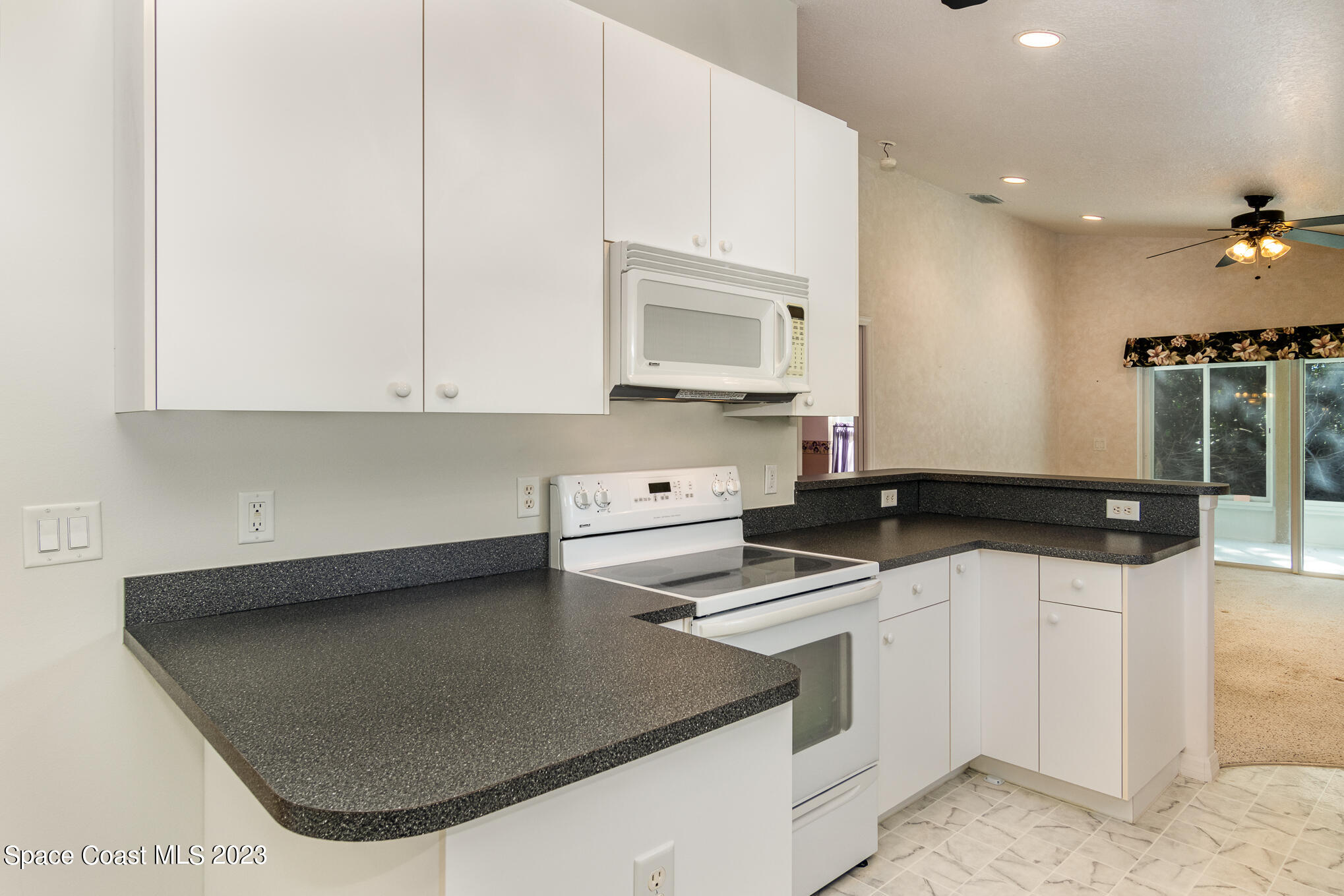2140 Spring Creek Circle Palm Bay, FL 32905 - Photo 9 of 22 a kitchen with stainless steel appliances granite countertop a sink stove and cabinets