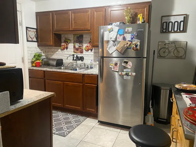 a kitchen with stainless steel appliances granite countertop a refrigerator and a stove