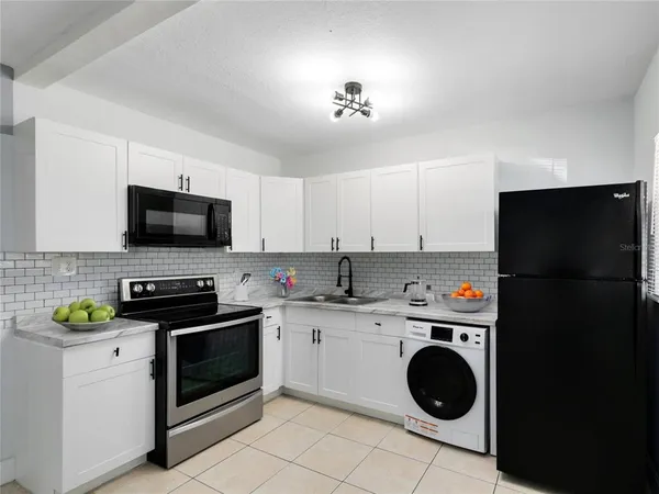 a kitchen with a sink a stove and cabinets