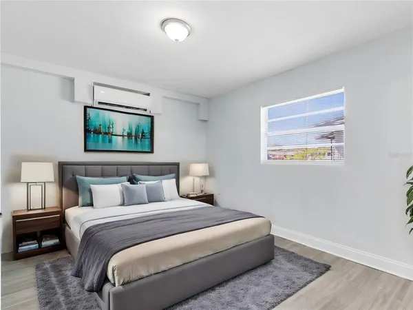a bedroom with a bed and a window