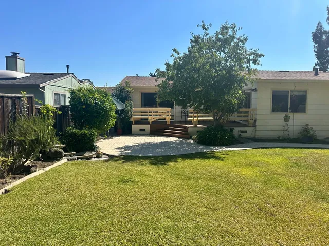 a view of a house with swimming pool and sitting area