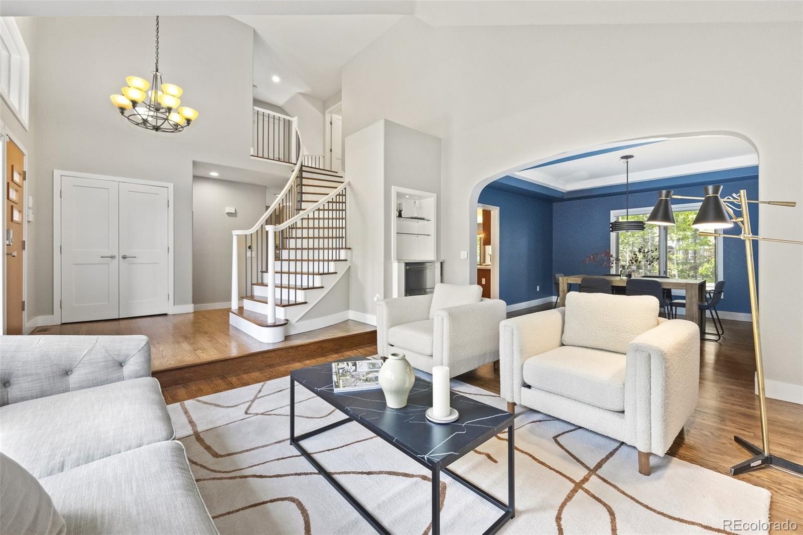 4141 South Hampton Circle Boulder, CO 80301 - Photo 4 of 35 a living room with furniture a chandelier and a dining table