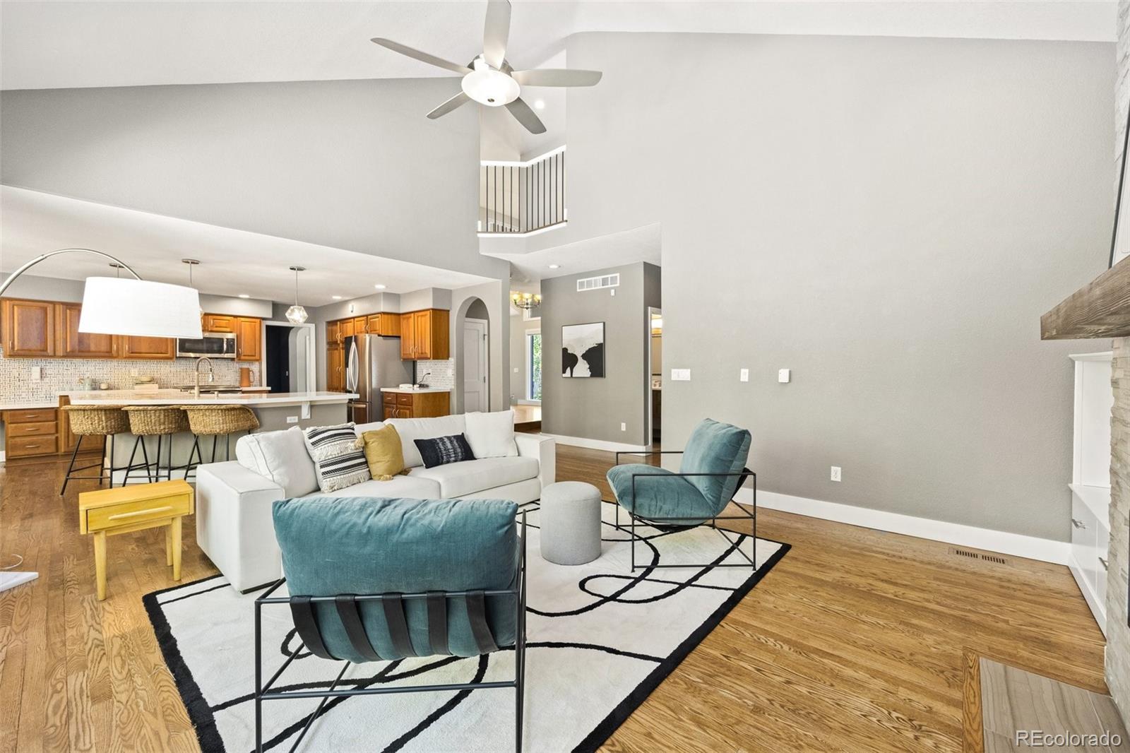 4141 South Hampton Circle Boulder, CO 80301 - Photo 10 of 35 a living room with furniture and a chandelier