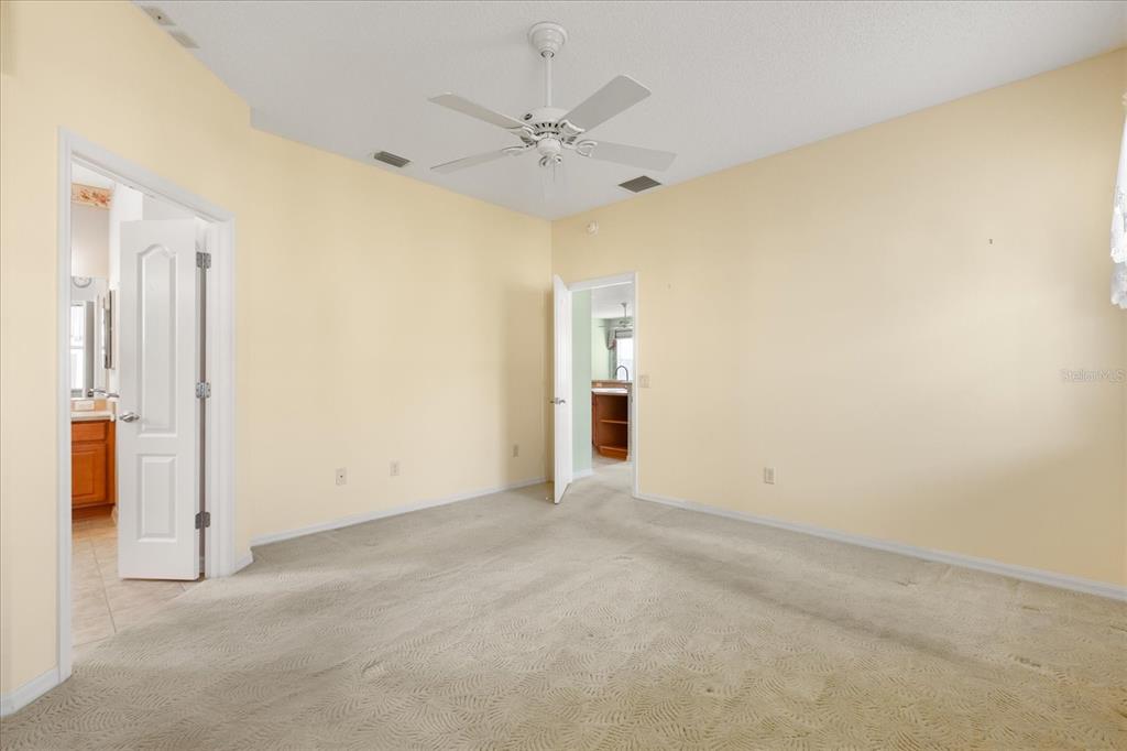 1424 Irwin Way The Villages, FL 32162 - Photo 12 of 28 an empty room with a ceiling fan and a window