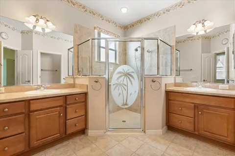 a spacious bathroom with a granite countertop sink a mirror and a vanity